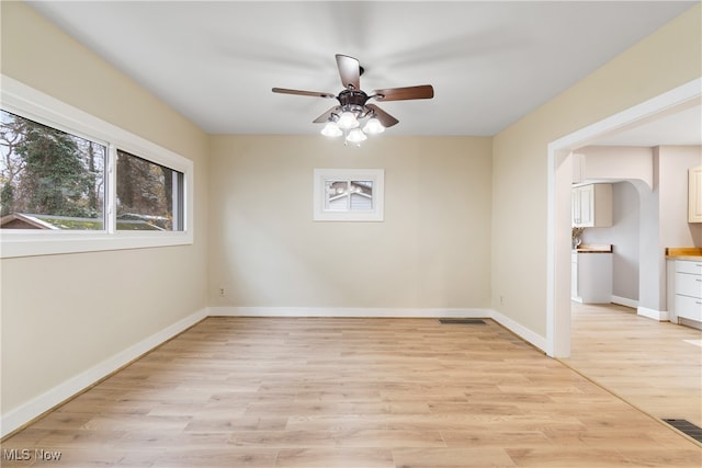 unfurnished room with ceiling fan and light wood-type flooring