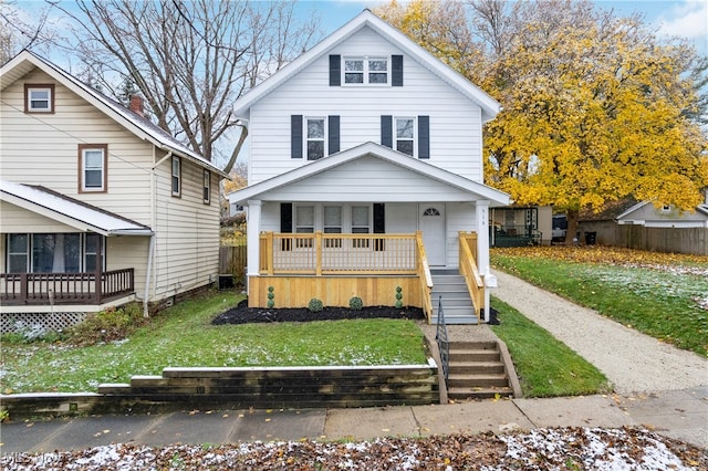 view of front property featuring a front yard and a porch