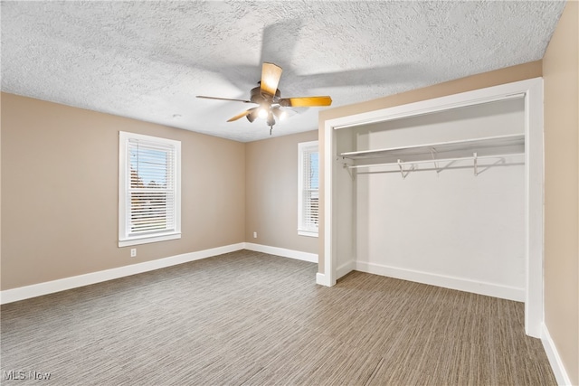 unfurnished bedroom with a textured ceiling, a closet, and ceiling fan