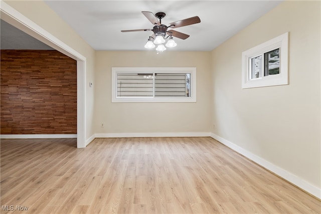 empty room featuring ceiling fan and light hardwood / wood-style flooring