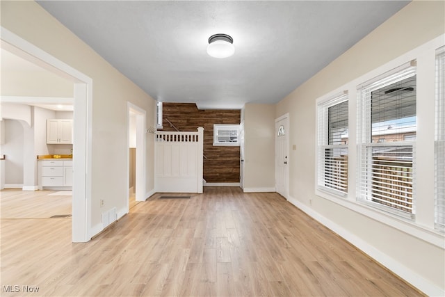 interior space featuring wood walls and light hardwood / wood-style flooring