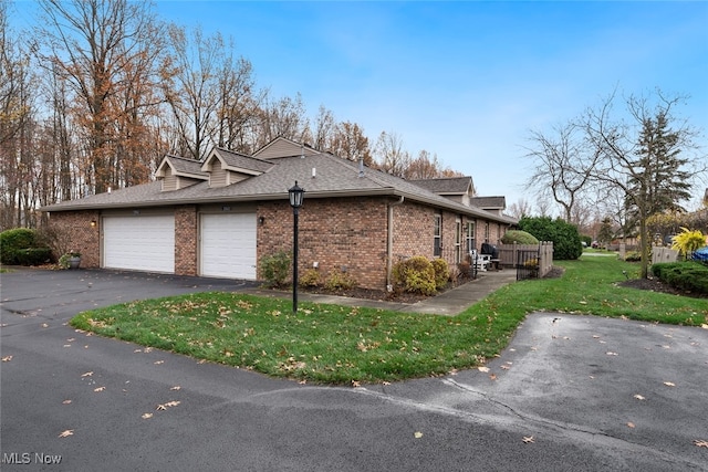 view of home's exterior with a lawn and a garage