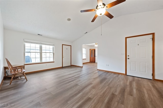 unfurnished living room with ceiling fan, light hardwood / wood-style floors, and high vaulted ceiling