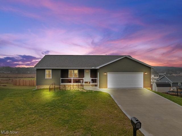 single story home with a porch, a garage, and a yard