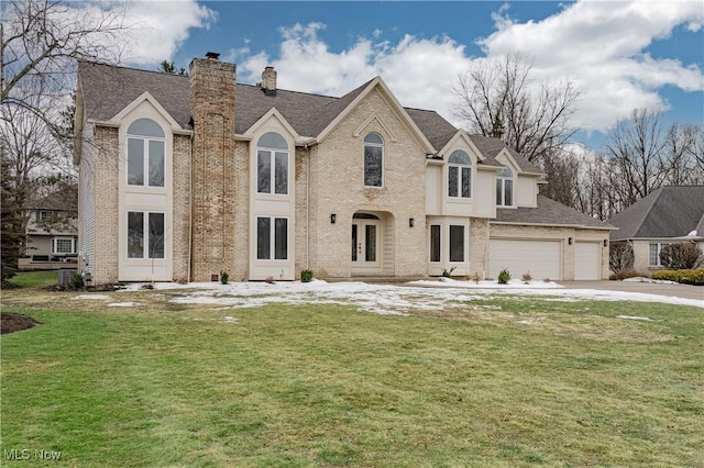 view of front of property with a garage and a front yard