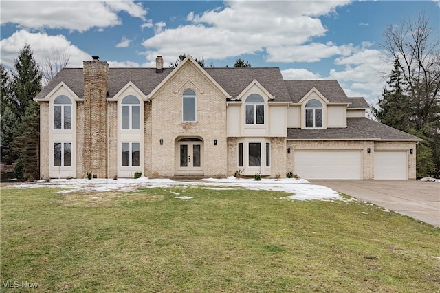 view of front of property featuring french doors, a garage, and a front lawn