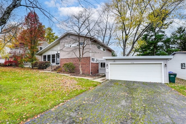 view of front of property with a garage and a front lawn