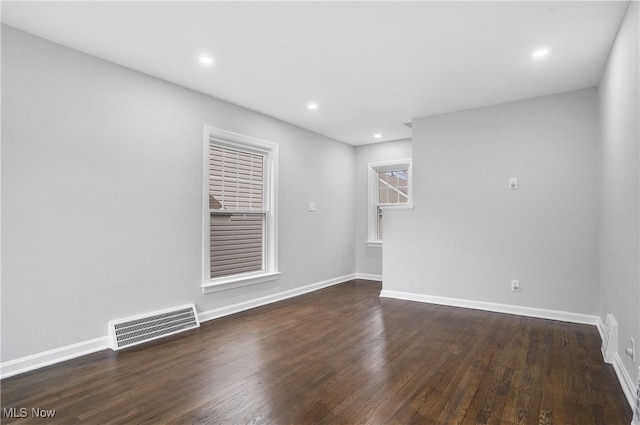 empty room with dark wood-type flooring