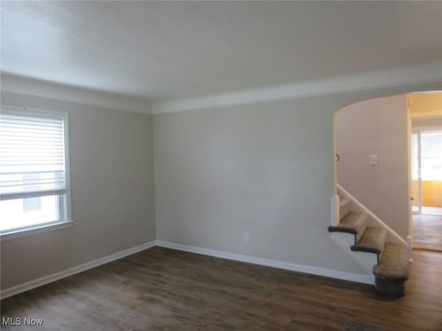 unfurnished room featuring dark hardwood / wood-style floors and a wealth of natural light