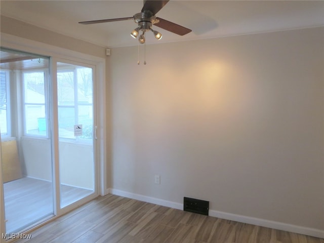 spare room featuring hardwood / wood-style flooring and ceiling fan