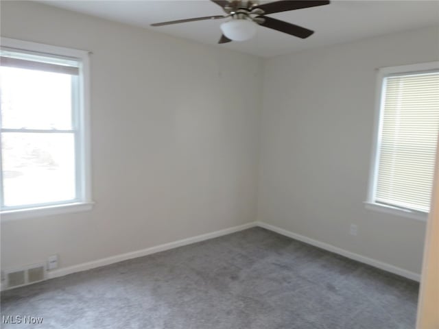 unfurnished room featuring ceiling fan and carpet floors