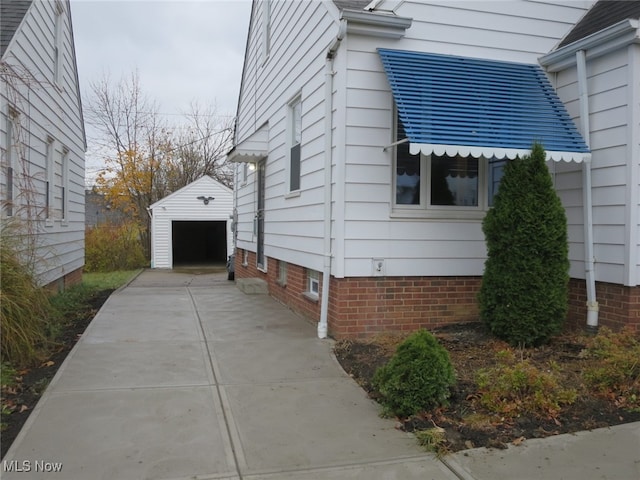 view of side of home featuring an outbuilding and a garage