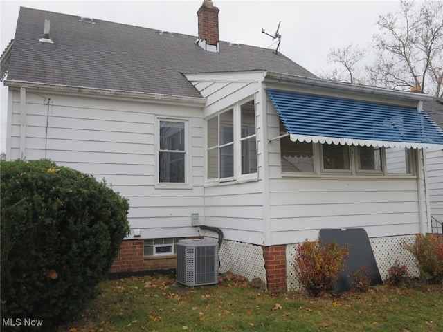 view of side of home featuring central AC unit