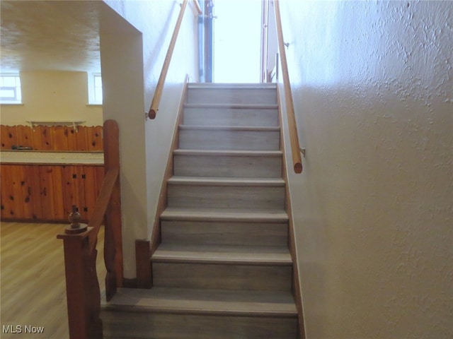 stairway featuring wood-type flooring