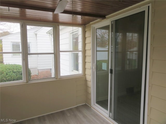 unfurnished sunroom with wood ceiling