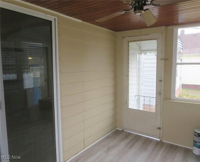 unfurnished sunroom with ceiling fan and wood ceiling