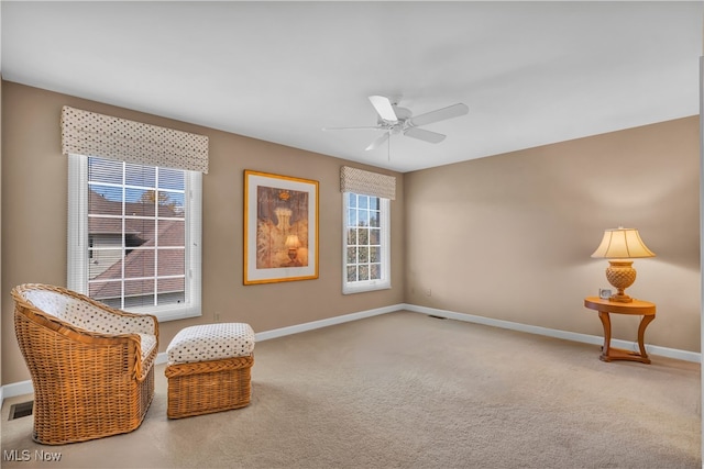 sitting room with ceiling fan and carpet floors