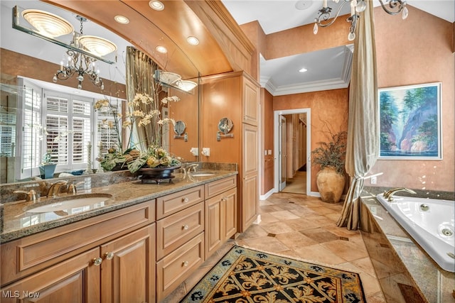 bathroom with tiled bath, vanity, a chandelier, and ornamental molding