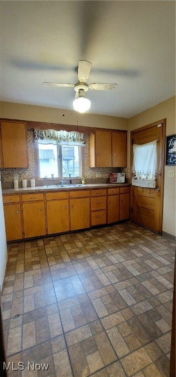 kitchen with ceiling fan and backsplash