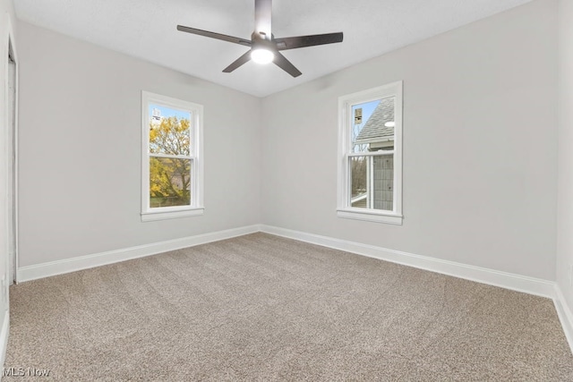 carpeted empty room featuring ceiling fan