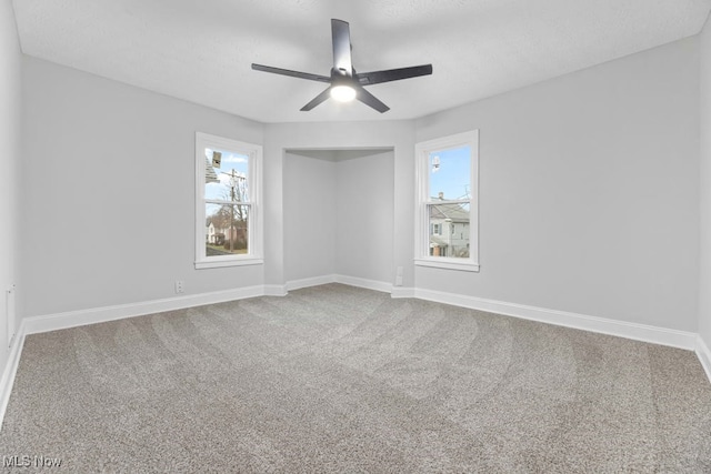 carpeted empty room with ceiling fan