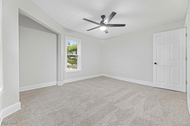 unfurnished room with ceiling fan and carpet floors