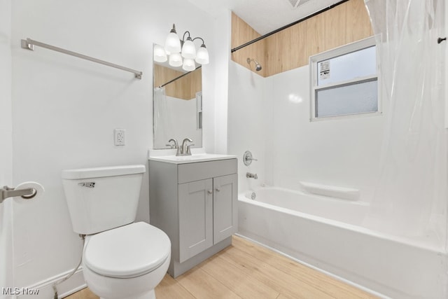 full bathroom with shower / washtub combination, hardwood / wood-style floors, vanity, and toilet