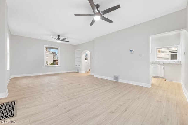 unfurnished living room with ceiling fan and light wood-type flooring