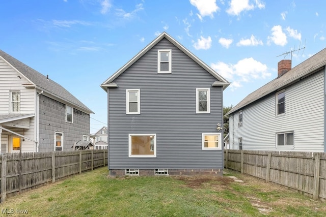 rear view of property with a lawn