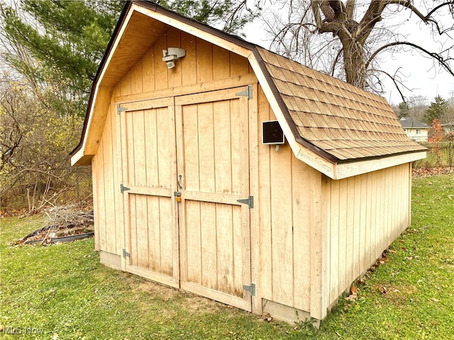 view of outdoor structure featuring a lawn