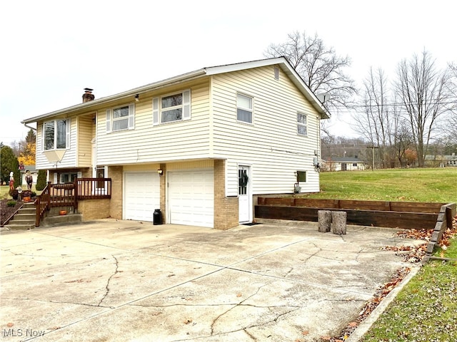 back of house with a garage and a deck