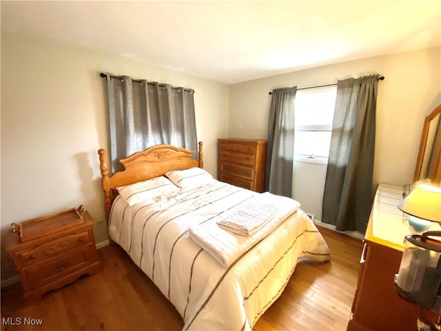 bedroom with wood-type flooring