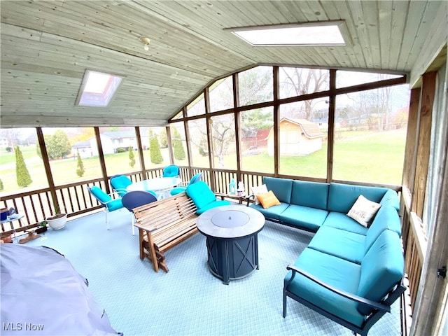 sunroom with wooden ceiling, lofted ceiling with skylight, and a healthy amount of sunlight