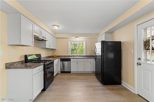 kitchen with a healthy amount of sunlight, light hardwood / wood-style flooring, black appliances, and white cabinets