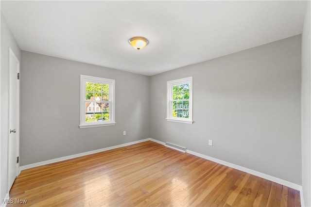 unfurnished room with a healthy amount of sunlight and light wood-type flooring