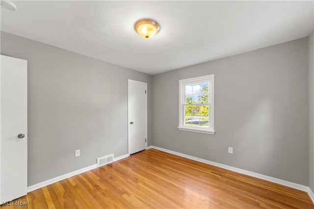 spare room with light hardwood / wood-style flooring