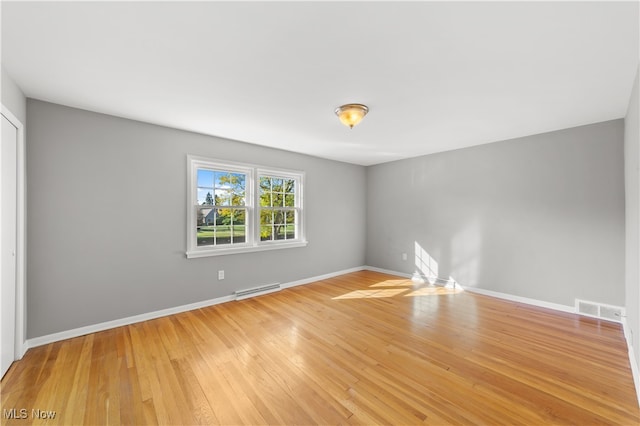 unfurnished room featuring hardwood / wood-style flooring