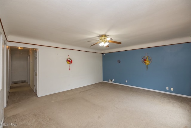 carpeted spare room with ceiling fan