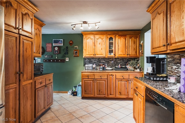 kitchen featuring decorative backsplash, light tile patterned flooring, and black dishwasher