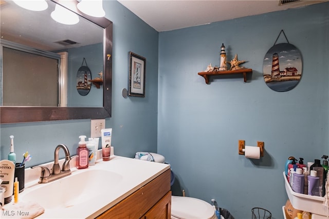 bathroom featuring vanity and toilet