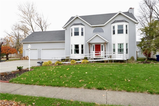 view of front facade with a front yard and a garage