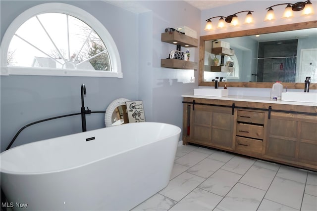 bathroom with vanity and shower with separate bathtub