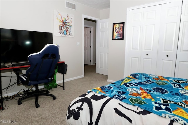 bedroom featuring a closet and light colored carpet