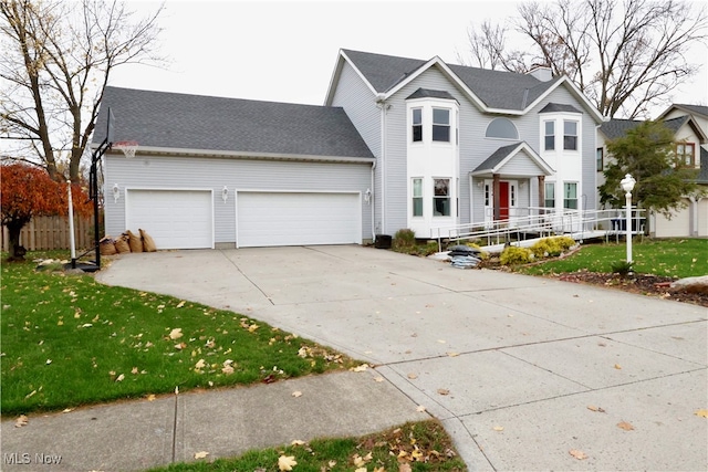 view of front property with a garage and a front yard