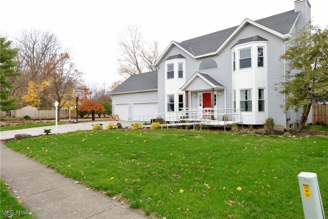 front facade featuring a garage and a front lawn