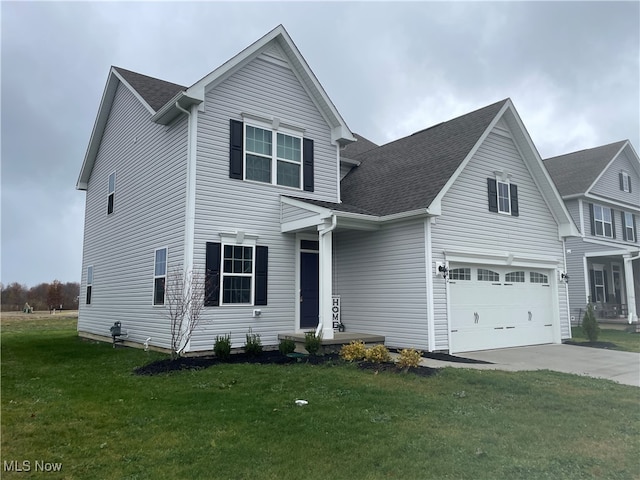 view of front of house with a front yard and a garage