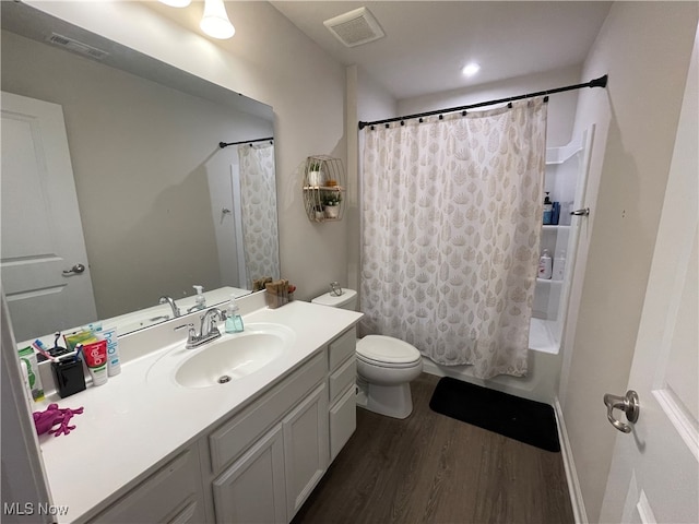 full bathroom with hardwood / wood-style flooring, vanity, toilet, and shower / bath combo with shower curtain