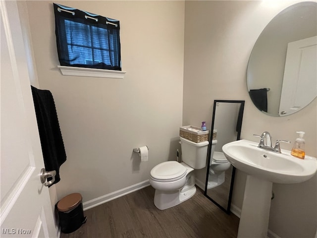 bathroom featuring hardwood / wood-style floors and toilet