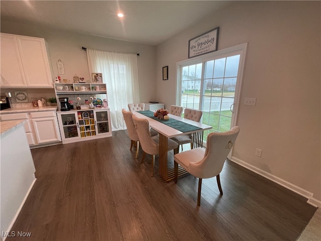 dining space with dark wood-type flooring