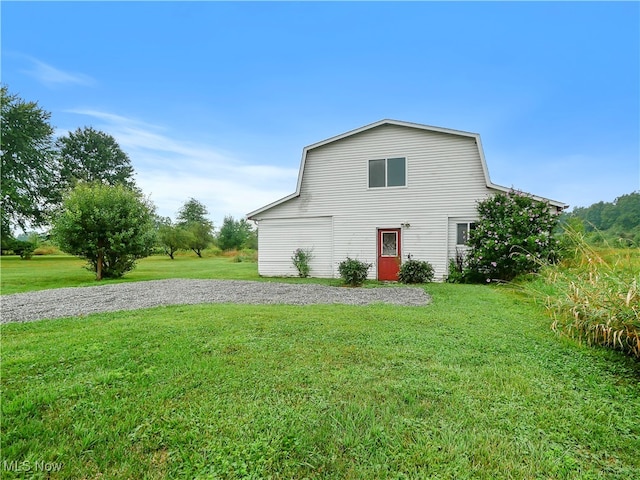 rear view of property with a yard